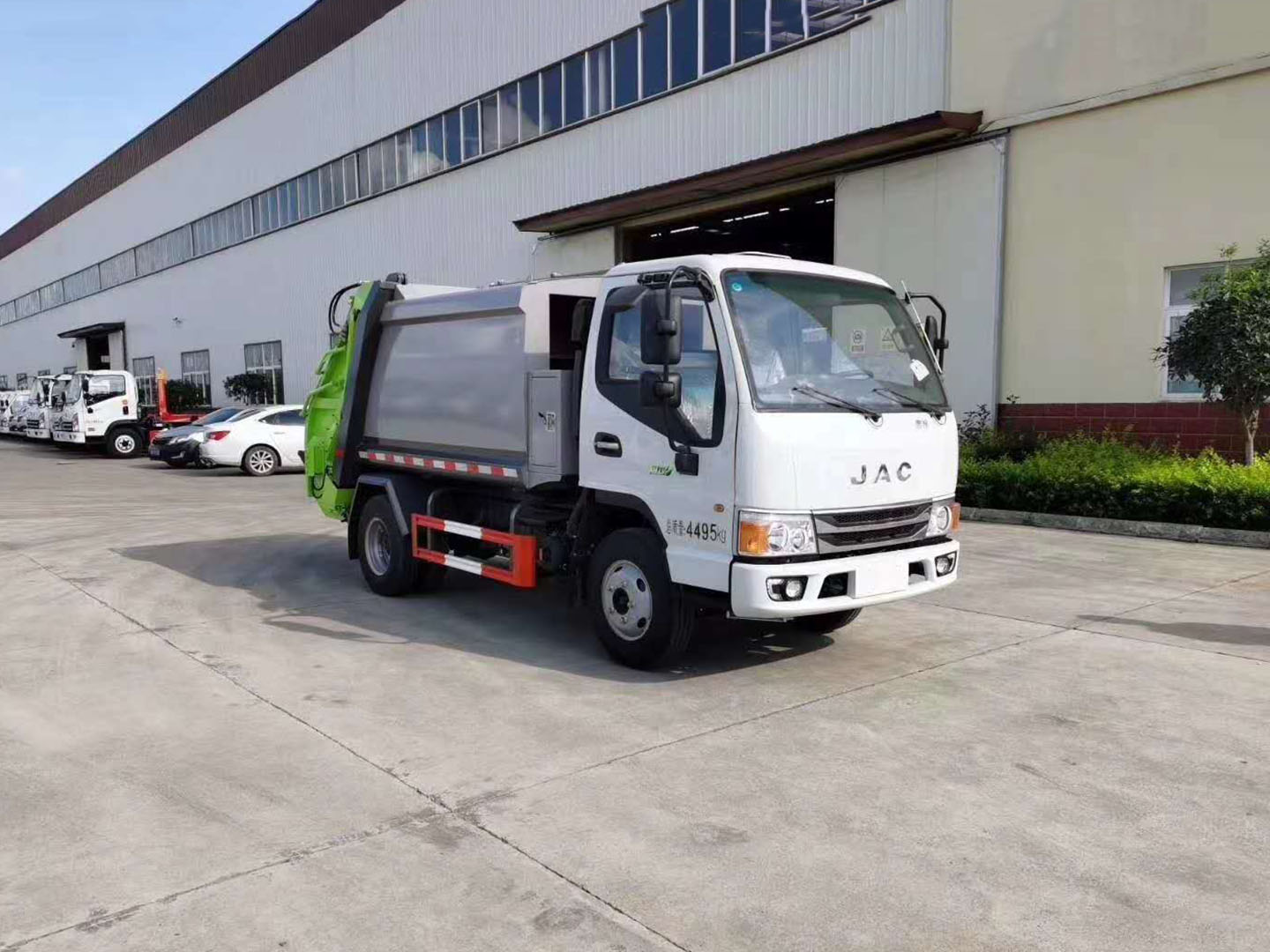 Rear view of JAC garbage truck working